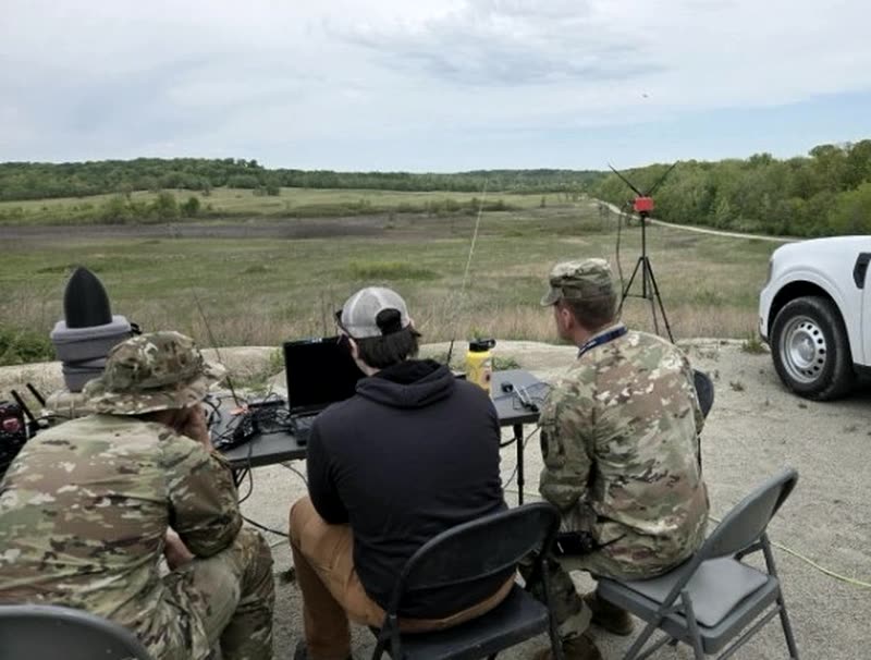 Operators at a range during T-REX 26-2, working a DaggerOS ground station with an antenna mast downrange.